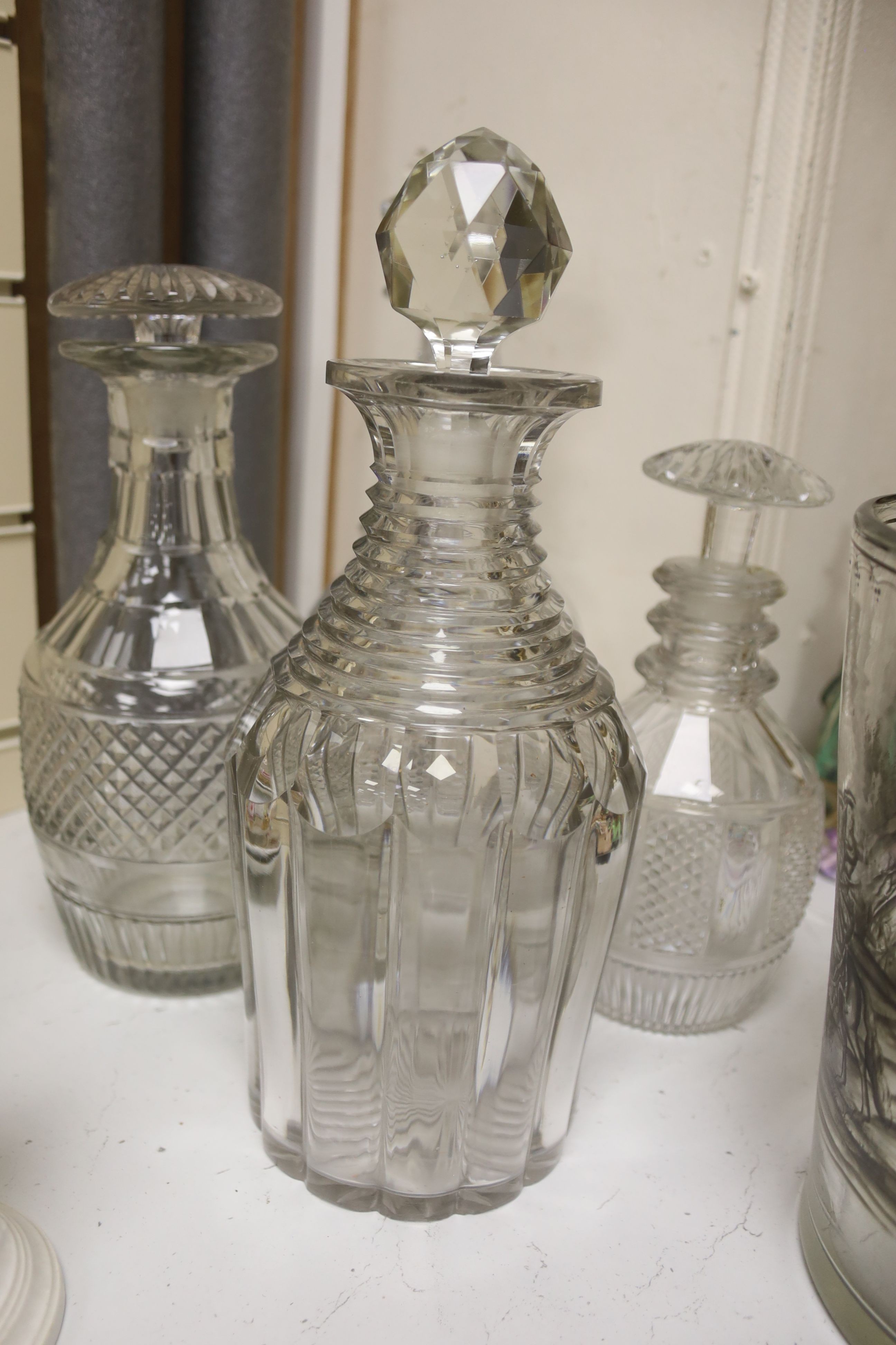 A glass vase with enamelled hunting scene with sundry decanters